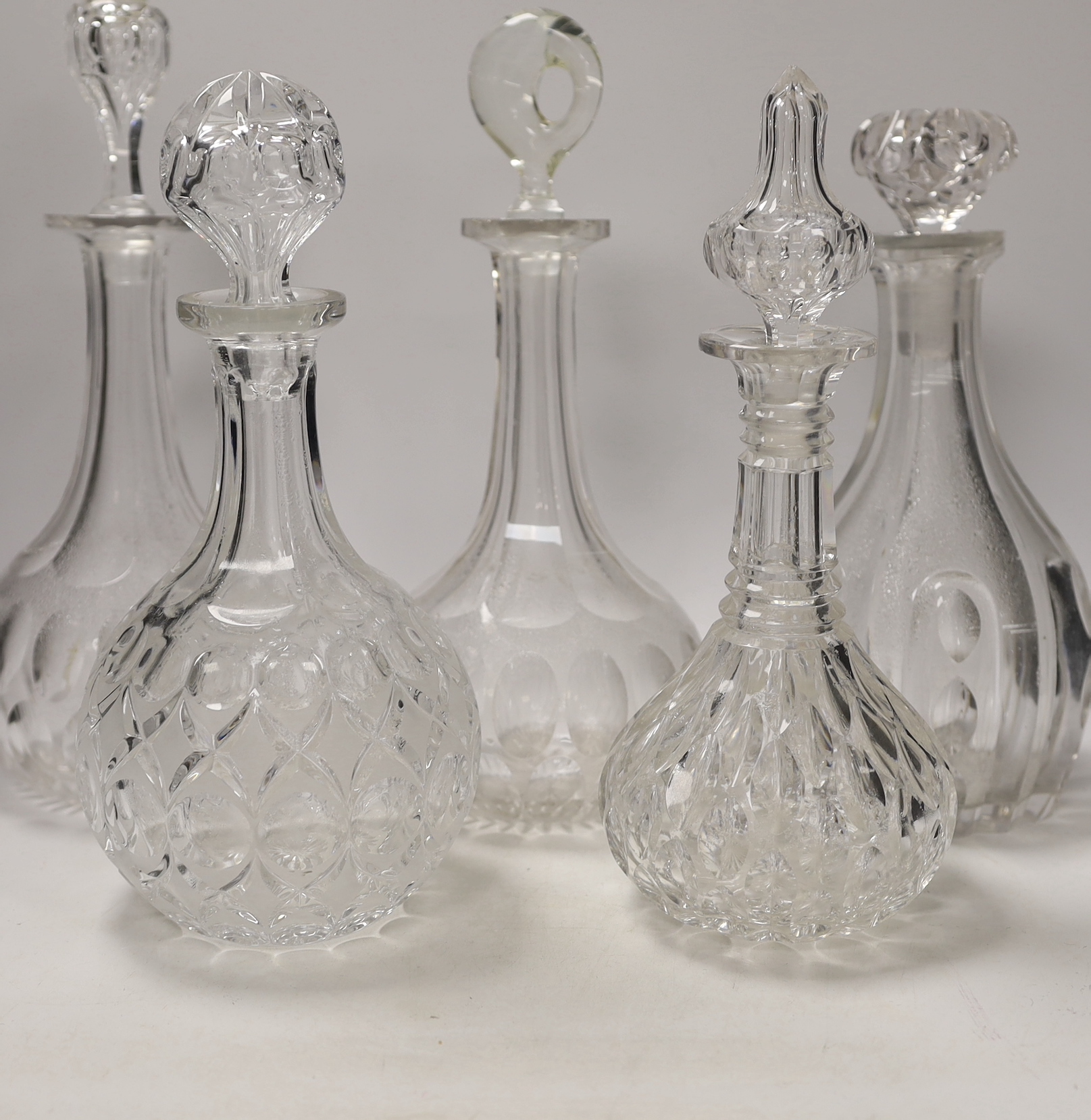 Seven decanters, all with stoppers, a carafe, a custard cup, tallest, decanter 34cm